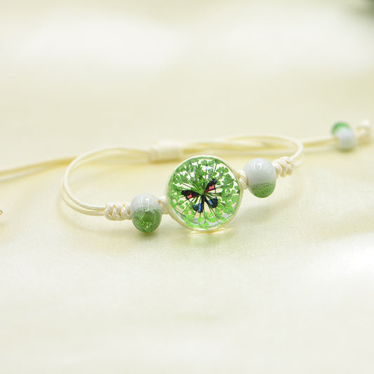 Handmade Butterfly Charm Bracelet with Floral Resin Center, Floral butterfly jewelry, Nature-inspired jewelry, Whimsical bracelet design, Delicate handmade jewelry